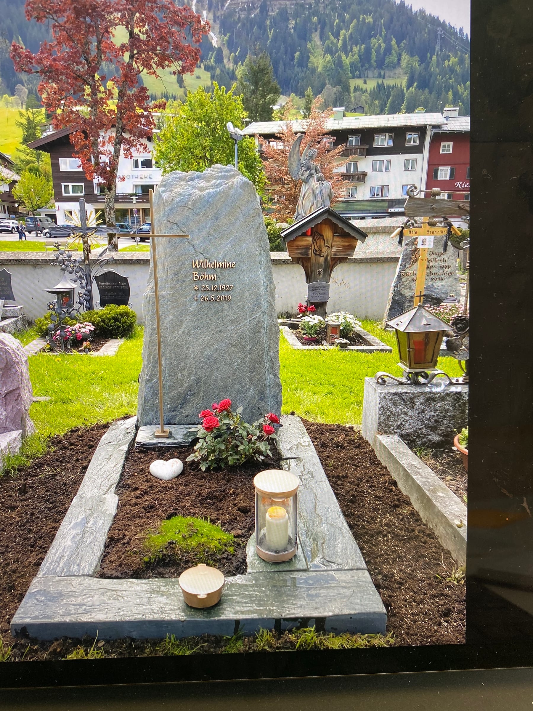Naturbelassener dunkelgrüner Diabas-Felsstein mit Goldkreuz auf dem Friedhof – STOI Steinmetzwerkstatt
